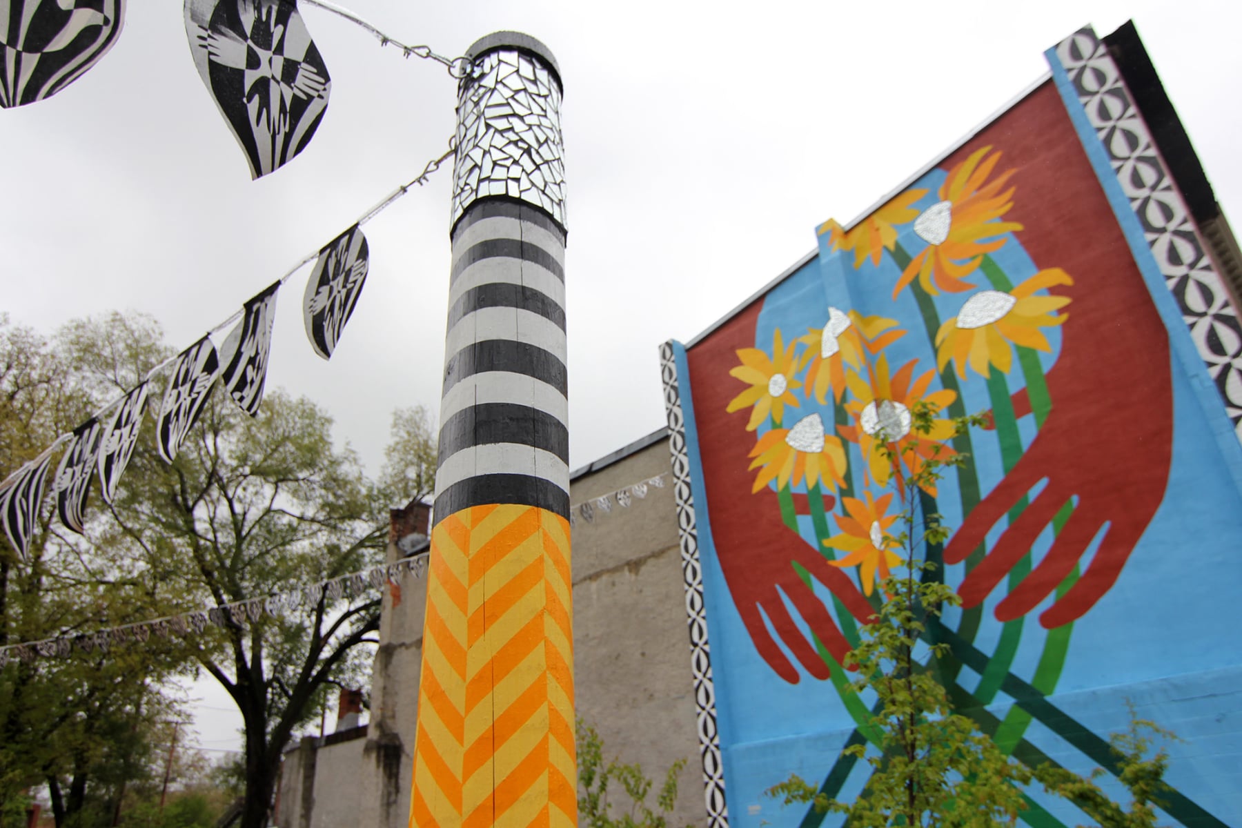 Sunflower Village garden mural diptych in Baltimore, MD by Emily C-D with Jessie and Katey (artist trio Can Collective), 2012.