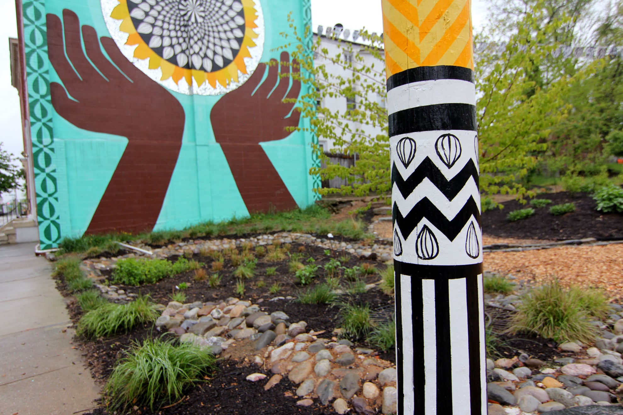 Sunflower Village garden mural diptych in Baltimore, MD by Emily C-D with Jessie and Katey (artist trio Can Collective), 2012.