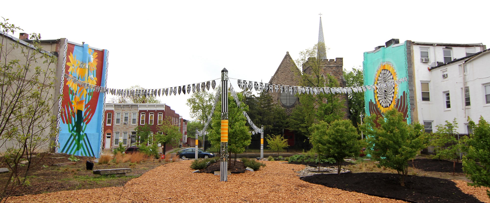Sunflower Village garden mural diptych in Baltimore, MD by Emily C-D with Jessie and Katey (artist trio Can Collective), 2012.